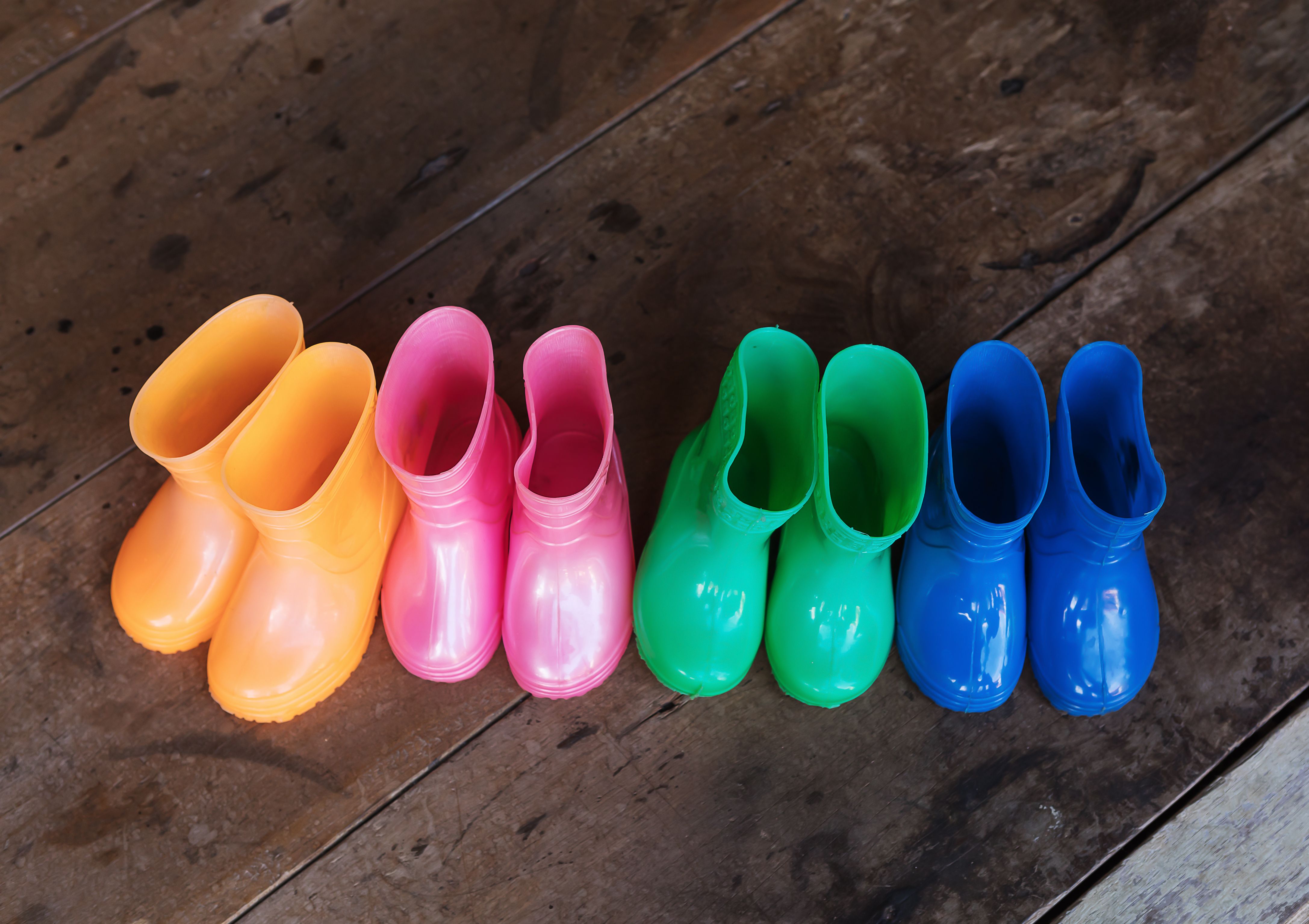 Row of colourful children's rain boots